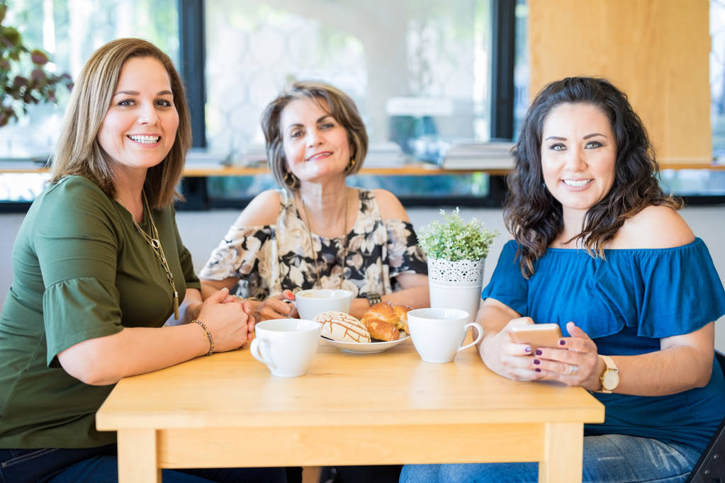 Beautiful middle aged female friends enjoying themselves at a restaurant